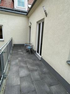 a patio with a table and a chair on a balcony at Paky Appartements 00313 in Bruck an der Leitha