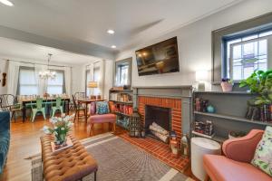 a living room with a fireplace and a dining room at Renovated Lubbock Home - Walk to Texas Tech! in Lubbock