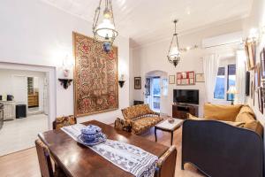 a living room with a table and a couch at Marcora's Historical Estate in Strongylí