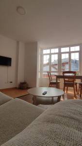 a living room with two beds and a table at Villa Xunqueira 2 in Cee