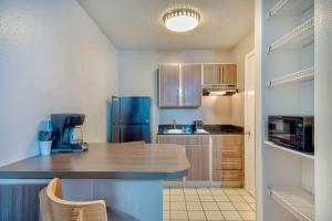 a kitchen with a counter and a blue refrigerator at Studio 6-San Antonio, TX - Medical Center in San Antonio