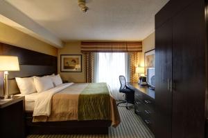 a hotel room with a bed and a desk at Comfort Inn Chatham in Chatham