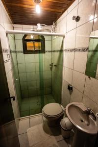 a bathroom with a shower and a toilet and a sink at Recanto das Águas in Eldorado