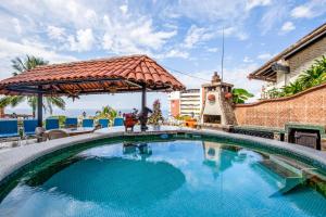 a swimming pool at a resort with a pavilion at Casa Anita in Puerto Vallarta