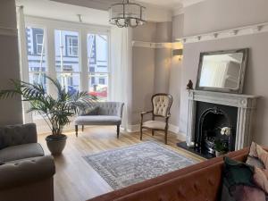 a living room with a couch and a fireplace at Seaclyffe Hotel Ltd in Llandudno