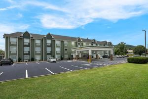 a large building with a parking lot in front of it at SureStay Plus Hotel by Best Western Sevierville in Sevierville