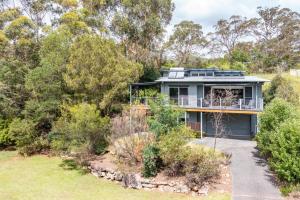 a house on a hill with trees at URALLA STUDIO - South Coast - Private Guest Suite in Bomaderry