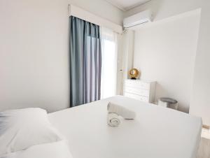 A bed or beds in a room at Acropolis View Dream Apartments