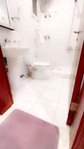 a white bathroom with a sink and a toilet at راما للاجنحة الفندقية in Jeddah