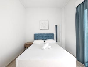 A bed or beds in a room at Acropolis View Dream Apartments