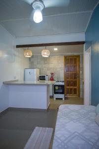 a kitchen with a counter and a stove in a room at Pousada Aldeia Portuguesa in Porto Seguro