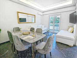 a dining room with a table and chairs and a couch at Acropolis View Dream Apartments in Athens