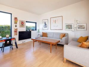 a living room with a couch and a table at 6 person holiday home in Væggerløse-By Traum in Væggerløse