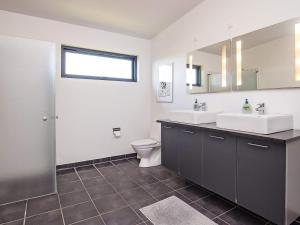 a bathroom with two sinks and a toilet at 6 person holiday home in Væggerløse-By Traum in Væggerløse +34 photos