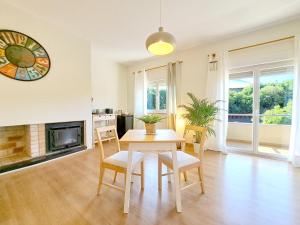 a dining room with a table and chairs and a fireplace at Villa Prana Guesthouse, Yoga & Ayurveda in Portimão