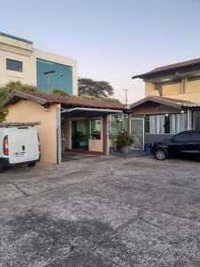 a car parked in a parking lot next to a building at Falcon Hotel in Bauru