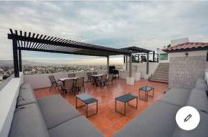 a patio with tables and chairs on a roof at Presidential Suite in Cabo San Lucas