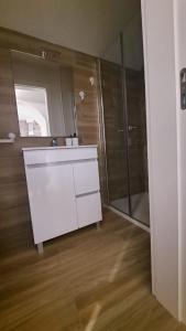 a bathroom with a white sink and a shower at Casa dos Albardeiros in Moura