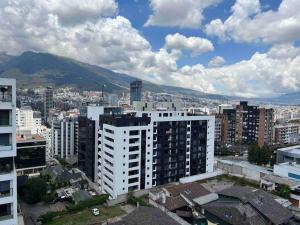 a view of a city with buildings and a mountain at #Amazing suite in the heart of Quito…. La carolina 3A in Quito
