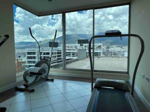 a gym with a view of a city from a window at #Amazing suite in the heart of Quito…. La carolina 3A in Quito