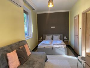 a bedroom with a bed and a couch at NEST1 Apartments in Keszthely