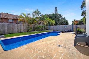 a swimming pool in a yard next to a fence at Ocean Spray 7 in Coffs Harbour
