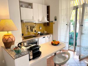a kitchen with a counter with a bowl of fruit on it at Apartments by the sea Opatija - Volosko, Opatija - 7846 in Volosko +7 photos