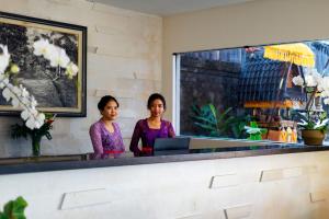 two women standing at a counter in a restaurant at Adepa Resort in Canggu