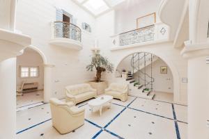 a living room with white furniture and a white floor at Villa Atrium in Makarska