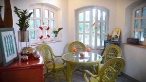 a dining room with a table and chairs and windows at La Casa Nonna in Alsóörs