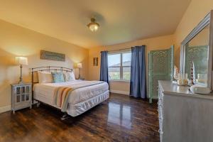 a bedroom with a bed and a large window at Elk Meadow Cabins Ranch Site Oreq-A in Orick