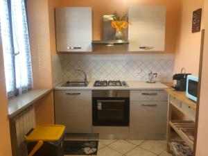 a small kitchen with a stove and a sink at Tenuta Fagnani in Lucca