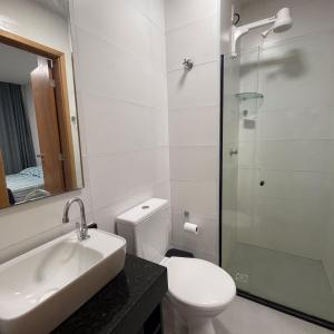 a bathroom with a toilet and a sink and a shower at Maraca Beach I - Flat 102 in Porto De Galinhas