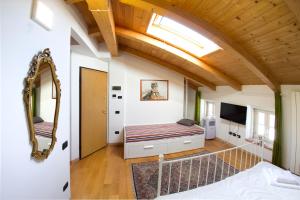 a bedroom with a bed and a mirror at Piazza Grande City Residence in Trieste