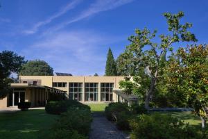 a large building with a tree in front of it at Quinta das Gerais in Marco de Canavezes