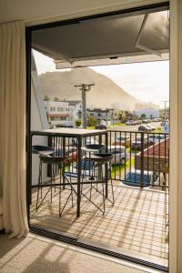 a balcony with a table and chairs on a balcony at Downtown Mount Maunganui in Mount Maunganui