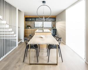 a kitchen and dining room with a table and chairs at Downtown Mount Maunganui in Mount Maunganui