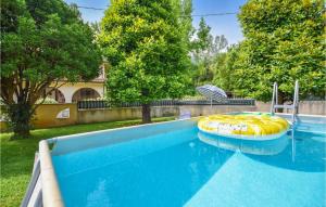 a swimming pool with a yellow and blue raft in a yard at Gorgeous Home In Camaiore With Wifi in Camaiore +26 photos