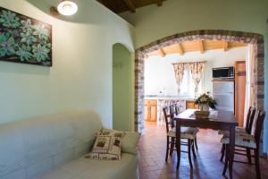 a living room with a couch and a table at Agriturismo Ada Musso ss in Diano Borello