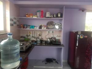 a kitchen with a large bottle of water on the counter at Sathya Sai Nivas in Puttaparthi