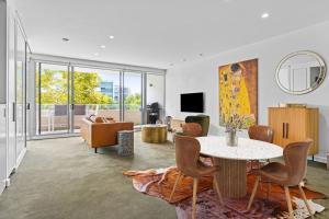 a living room with a table and chairs at Apartment on Honeysuckle in Newcastle