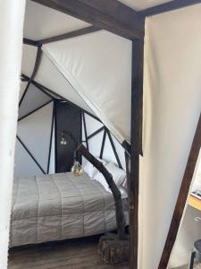 a bedroom with a tent with a bed in it at Glamping ecoglam Medellín in Copacabana