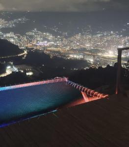 a bridge over a body of water at night at Glamping ecoglam Medellín in Copacabana