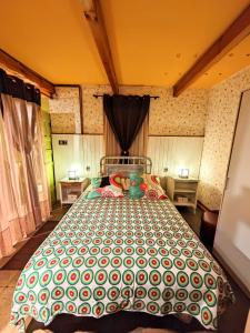 a bedroom with a large bed with a green and white comforter at Casa Manuel y Ana María. 