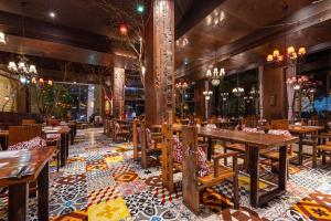 a restaurant with wooden tables and chairs on a tiled floor at Xiamen Xiang An Yi Hao Hotel in Xiamen