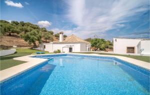 a large swimming pool in front of a house at Nice Home In Algar With Outdoor Swimming Pool, Wifi And 7 Bedrooms in Algar