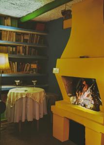 a yellow fireplace in a room with a table at Hotel Finca el Recreo in Guasca