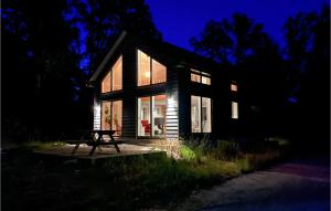 a house with a picnic table in front of it at night at Awesome Home In Hrby With Wifi in Hörby