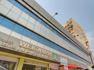 a building with a sign for the melbourne australian architecture at Collection O Alekhya Residency in Hyderabad
