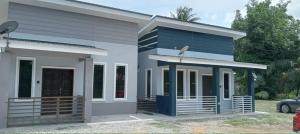 a house with a blue and white facade at D'NAS HOMESTAY - Muslm Only in Sungai Besar